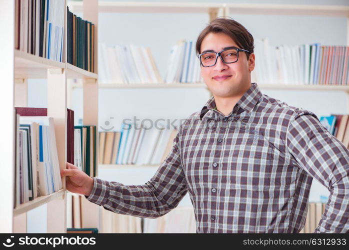 Young student looking for books in college library