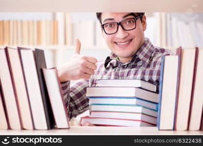 Young student looking for books in college library