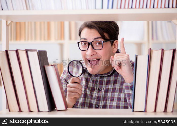 Young student looking for books in college library