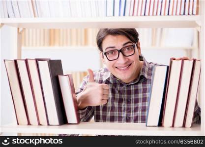 Young student looking for books in college library
