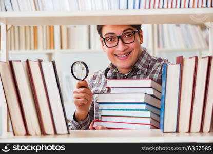 Young student looking for books in college library