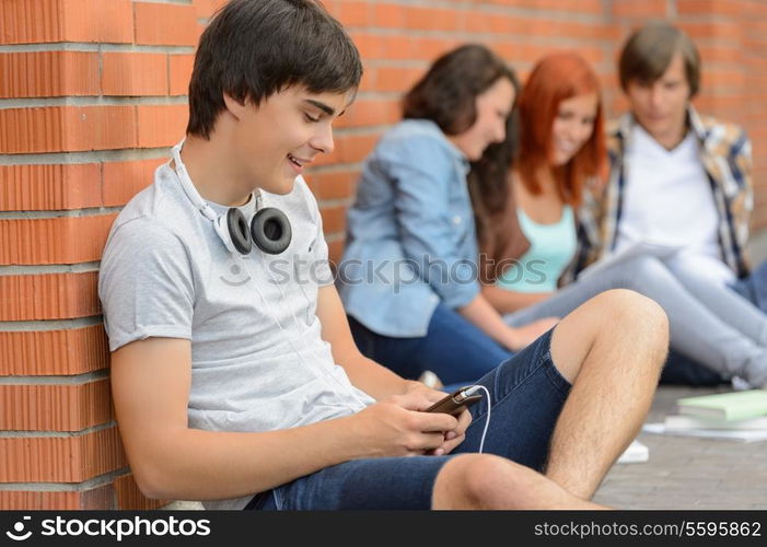 Young student man hanging out with college friends sitting ground