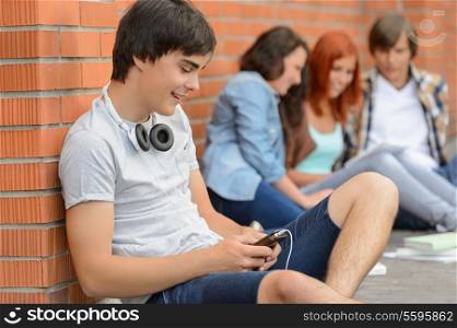 Young student man hanging out with college friends sitting ground