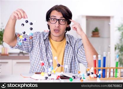Young student physicist preparing for exam at home   . Young student physicist preparing for exam at home    