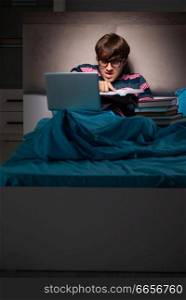 Young student preparing for exams at night at home 