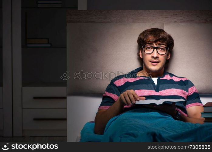 Young student preparing for exams at night at home 