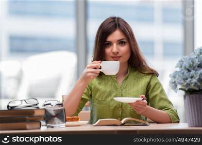 Young student preparing for exams drinking tea