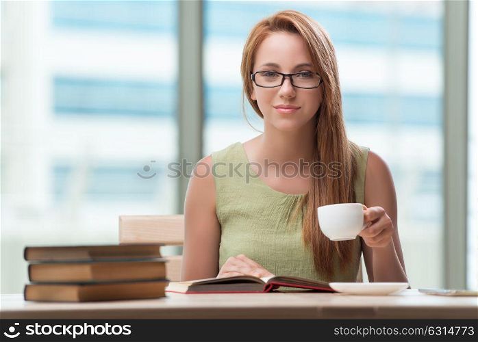 Young student preparing for exams drinking tea