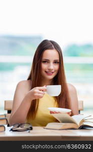 Young student preparing for exams drinking tea