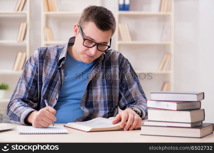 Young student preparing to school exams with books