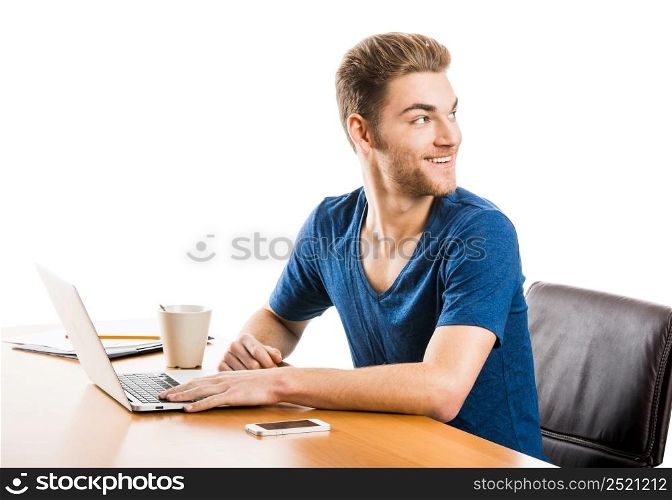 Young student sitting on the desk working with a laptop