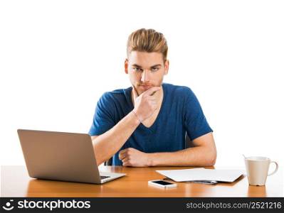 Young student sitting on the desk working with a laptop