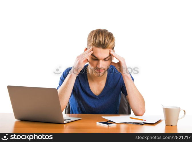 Young student sitting on the desk working with a laptop