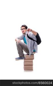 Young student sitting on top of book stack on white
