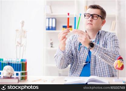 Young student studying chemistry in university
