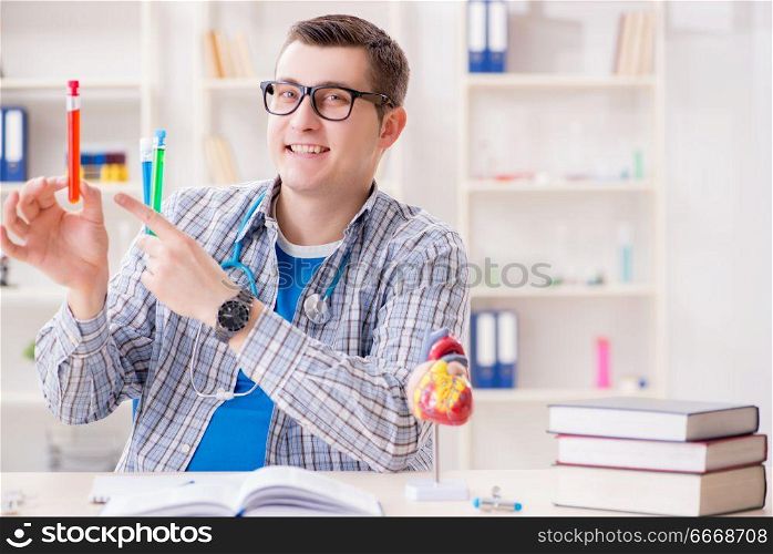 Young student studying chemistry in university