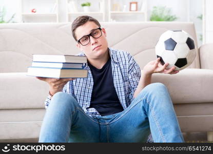 Young student trying to balance studying and playing football