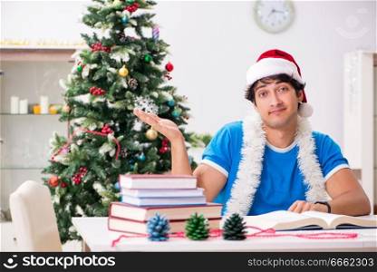 Young student with book at Christmas eve 