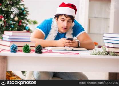 Young student with book at Christmas eve . The young student with book at christmas eve 