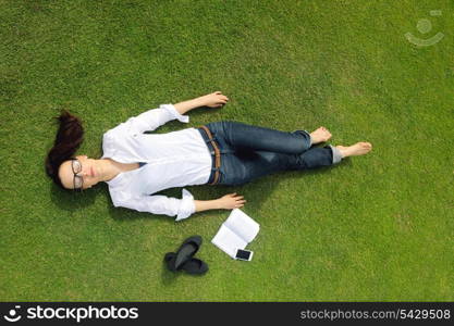 Young student woman reading a book and study in the park