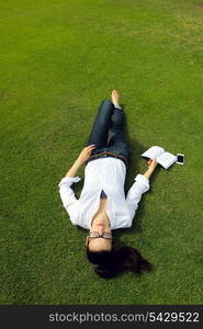 Young student woman reading a book and study in the park