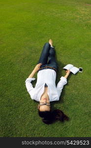 Young student woman reading a book and study in the park