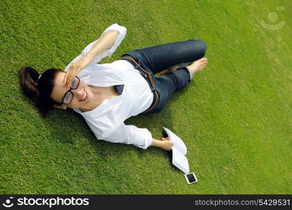 Young student woman reading a book and study in the park