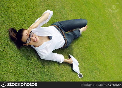 Young student woman reading a book and study in the park