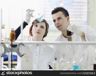 young students couple making test in bright labaratory