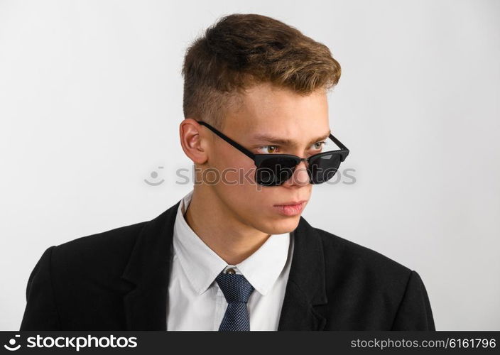 young stylish businessman. portrait of young stylish businessman on gray background