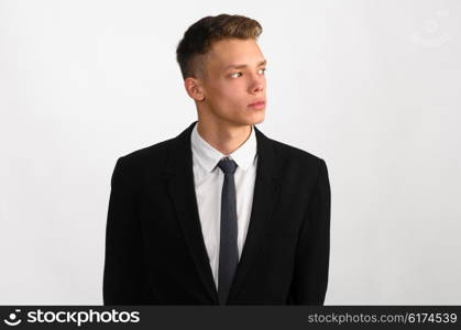 young stylish businessman. portrait of young stylish businessman on gray background