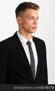 young stylish businessman. portrait of young stylish businessman on gray background