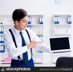 Young stylish businessman working in the office. The young stylish businessman working in the office