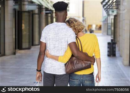 young stylish couple hugging in the city