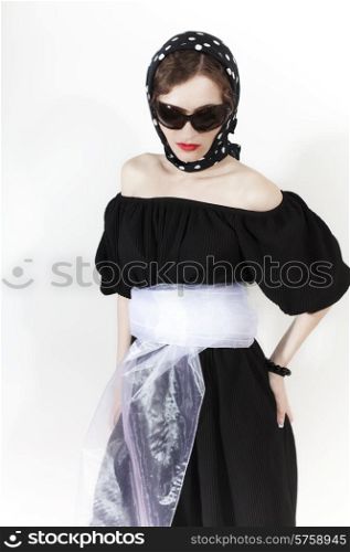 Young stylish woman wearing headscarf and sunglasses on white background