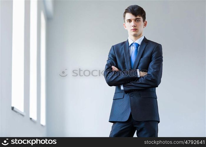 Young successful businessman. Image of handsome confident businessman in business suit