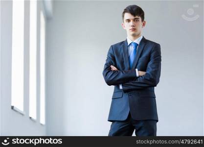 Young successful businessman. Image of handsome confident businessman in business suit