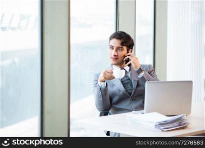 Young successful businessman working at the office 