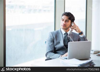 Young successful businessman working at the office 