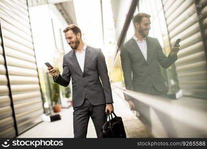 Young successful man  executive businessman using his mobile cell phone