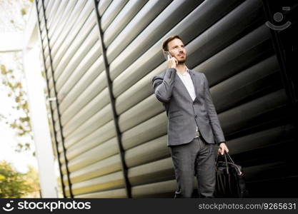 Young successful man  executive businessman using his mobile cell phone