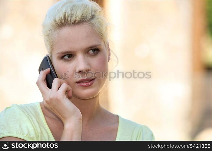 Young summery woman using a cellphone