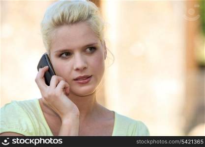 Young summery woman using a cellphone