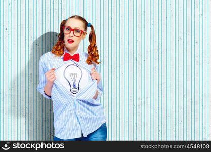 Young super hero woman. Young woman acting like super hero with bulb illustration on chest