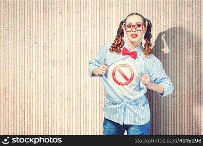 Young super hero woman. Young woman acting like super hero with sign on chest