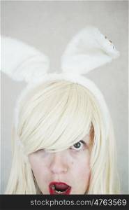 Young surprised woman wearing bunny ears