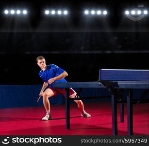 Young table tennis player at sports hall