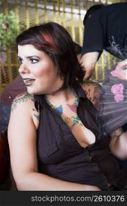Young tattooed woman hanging out, night