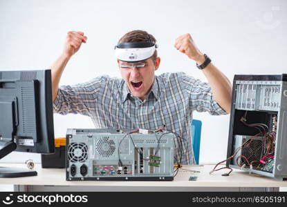 Young technician repairing computer in workshop