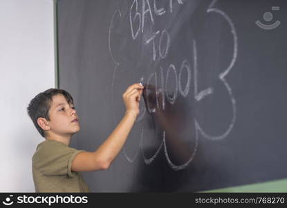 "Young teen and blackboard with " back to school " written . Education concept"